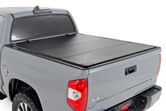 Rough Country Hard Tri-Fold Flip Up Bed Cover | 5'7" Bed | Toyota Tundra 2WD/4WD (07-21)