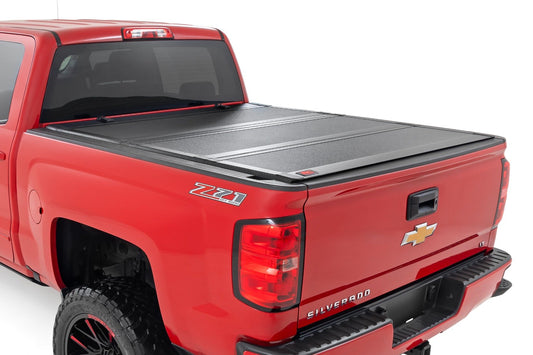 Rough Country Hard Tri-Fold Flip Up Bed Cover | 6'7" Bed | Rail Cap | Chevy/GMC 1500/2500HD/3500HD (14-19)